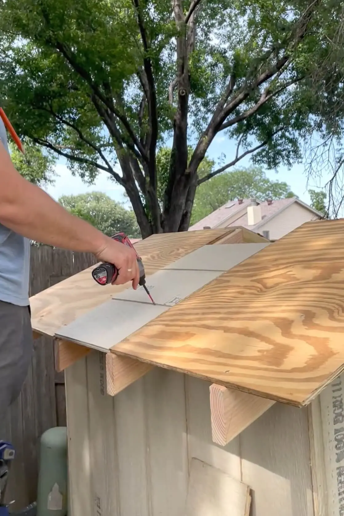 Adding sheeting to the chicken coop roof.